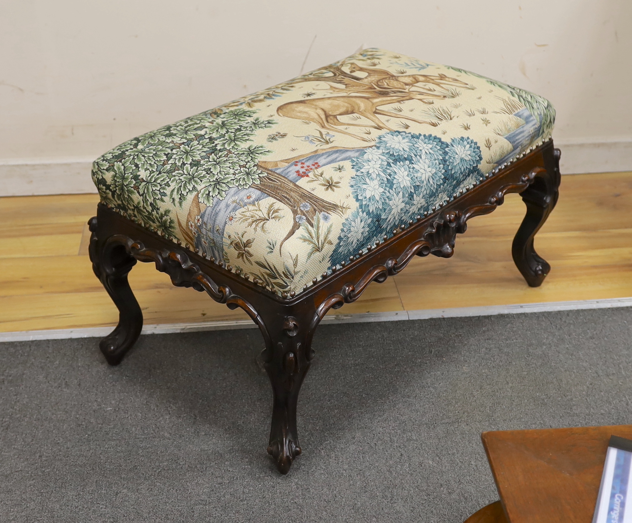 A Victorian carved mahogany dressing stool, re-upholstered in a William Morris-designed fabric, The Brook Tapestry, width 80cm, depth 50cm, height 44cm